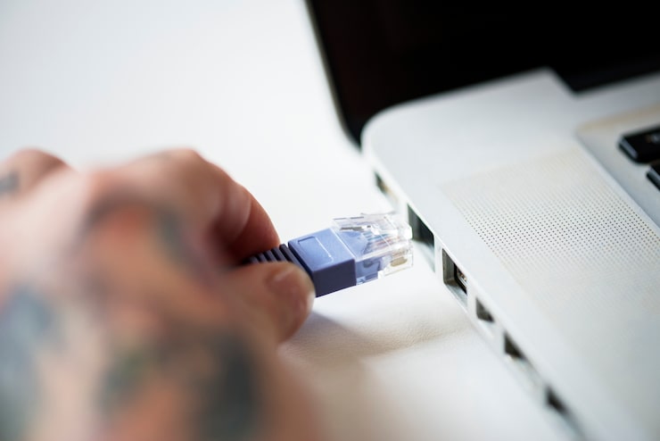 Connecting a LAN cable to JioFiber router to fix packet loss and high ping for competitive multiplayer gaming.