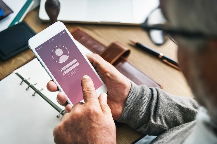A person using a smartphone for PMAY status check with mobile number and Aadhaar.
