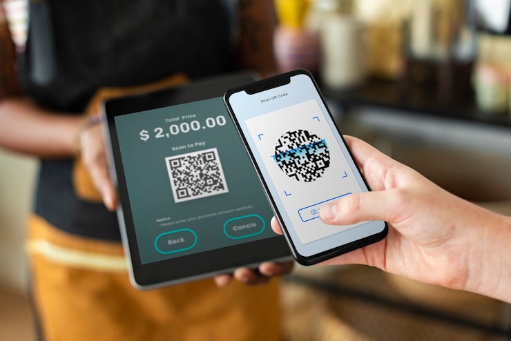 Diagram showing a customer scanning a UPI QR code with a smartphone to transfer money to a merchant bank account.